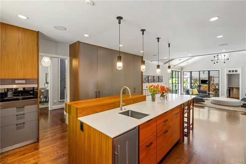 Kitchen with a sink, dark wood-type flooring, lofted ceiling, modern cabinets, and open floor plan