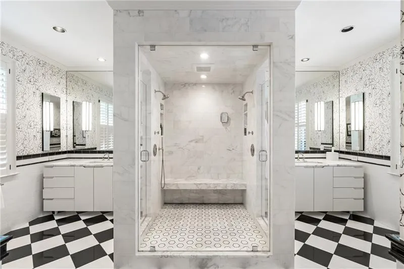 Bathroom featuring crown molding, a stall shower, tile patterned floors, recessed lighting, and two vanities