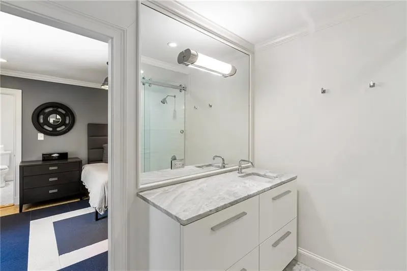 Full bath with crown molding, a shower stall, vanity, toilet, and tile patterned floors