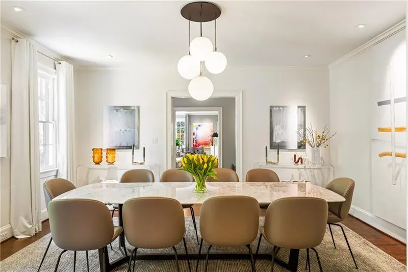 Dining room with dark wood-style floors, ornamental molding, baseboards, and recessed lighting