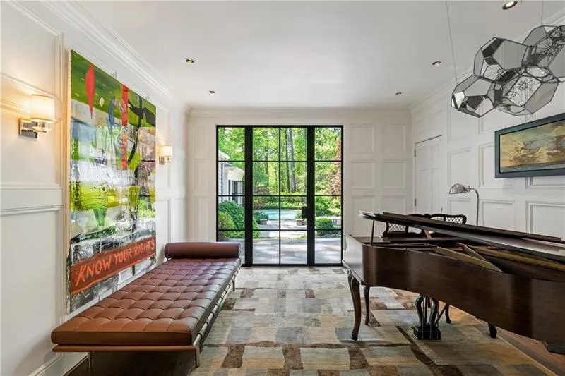 Sitting room featuring a decorative wall and ornamental molding