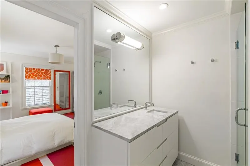 Bathroom featuring crown molding, a stall shower, vanity, baseboards, and recessed lighting