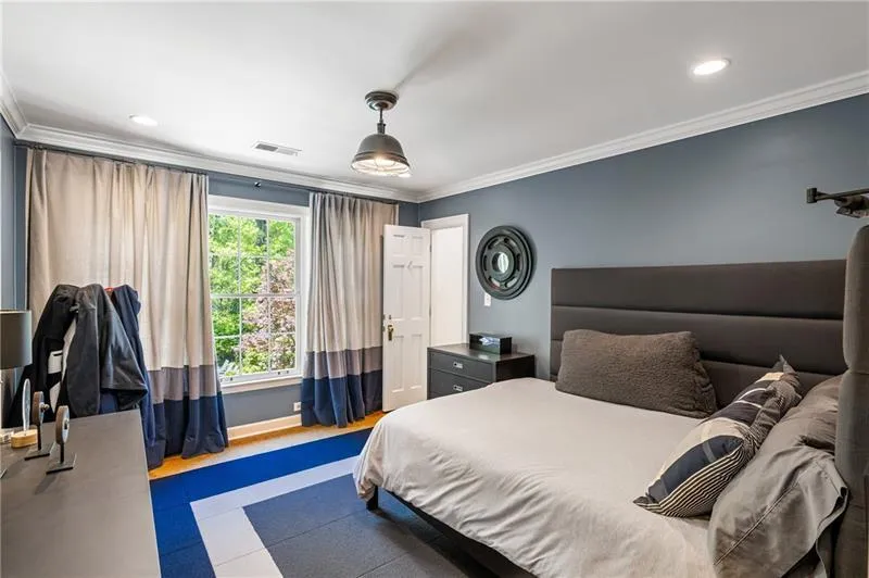 Bedroom with crown molding, baseboards, and recessed lighting