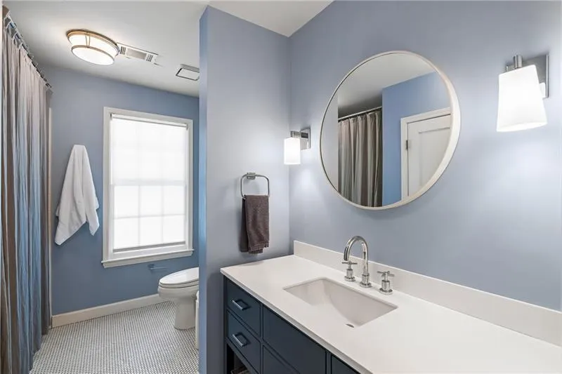 Bathroom with baseboards, toilet, vanity, and tile patterned floors