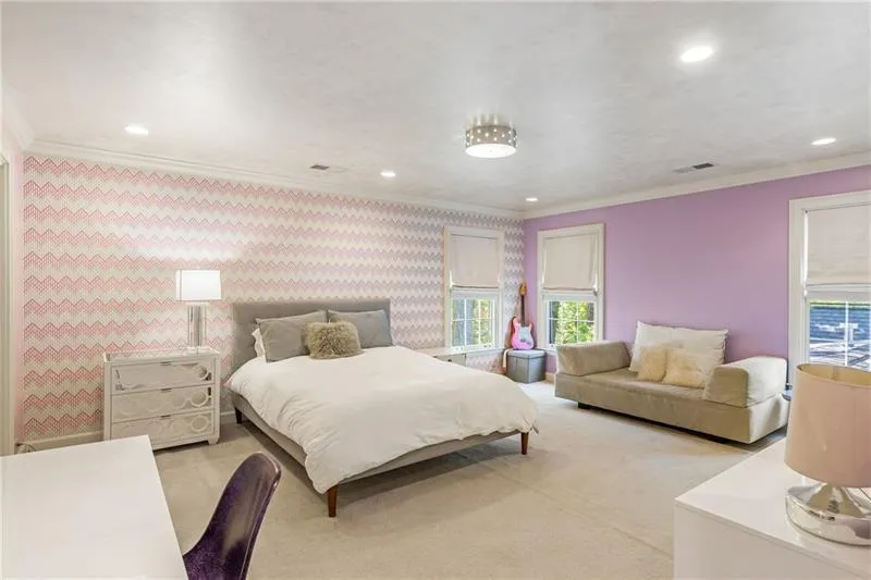 Bedroom with recessed lighting, light carpet, crown molding, and wallpapered walls