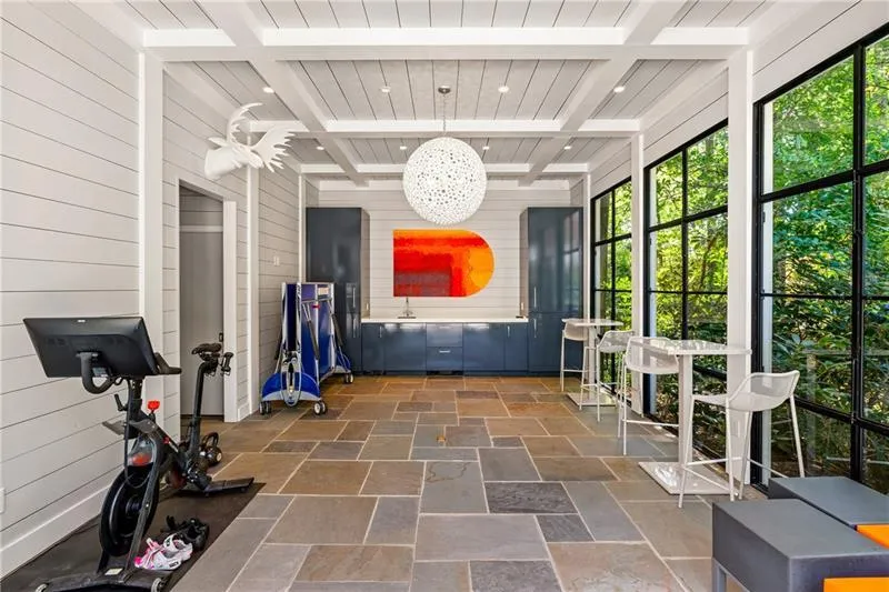 Sunroom with healthy amount of natural light and beamed ceiling