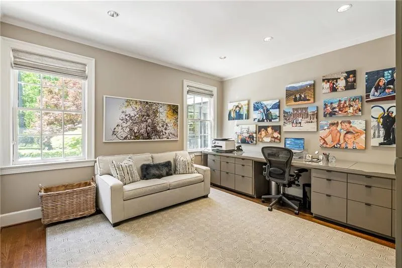 Office space with plenty of natural light, light wood-style floors, ornamental molding, recessed lighting, and baseboards