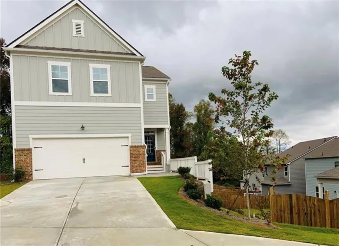 Two-story exterior with light gray siding and vertical board and batten accents