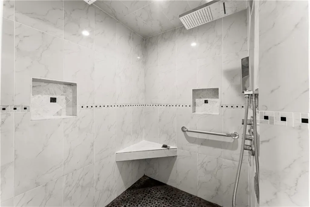 Bathroom featuring a marble finish shower