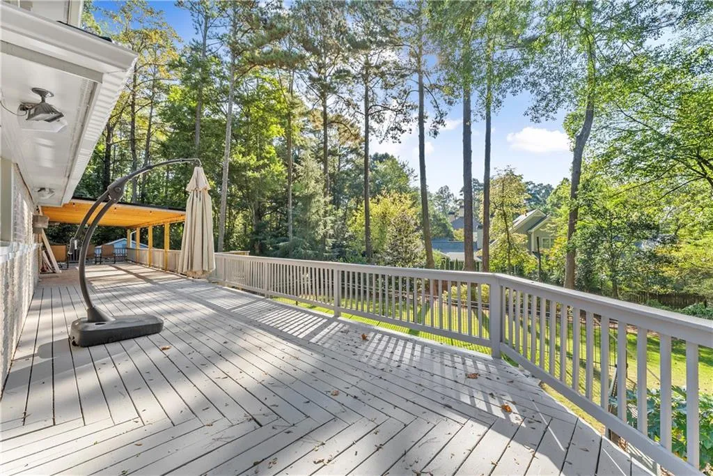 Wooden terrace with view of wooded area
