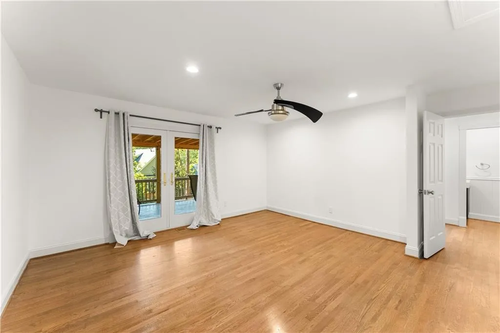 Empty room featuring french doors, light wood-style floors, recessed lighting, and a ceiling fan