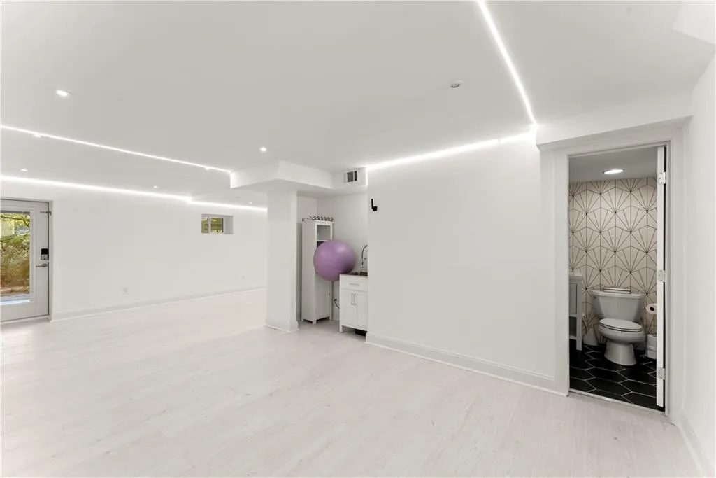 Below grade area featuring recessed lighting and light wood finished floors