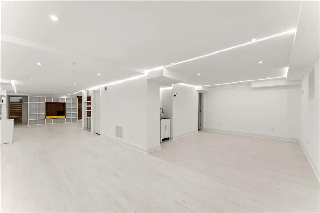 Unfurnished living room with recessed lighting, light wood-style floors, and built in features