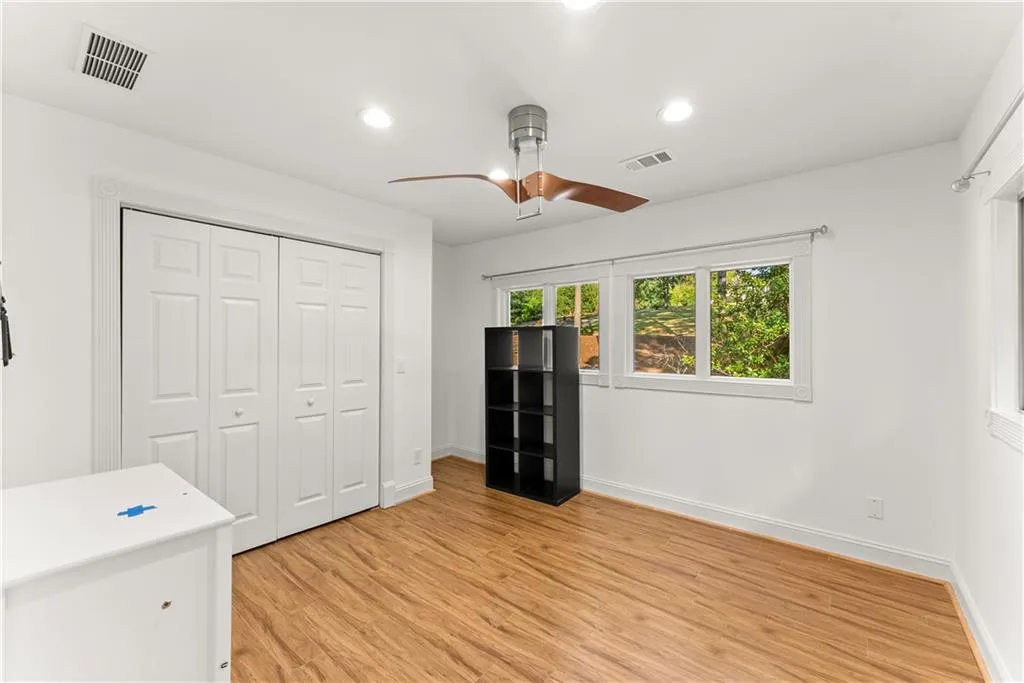 Unfurnished bedroom with ceiling fan, a closet, light wood-style flooring, and recessed lighting