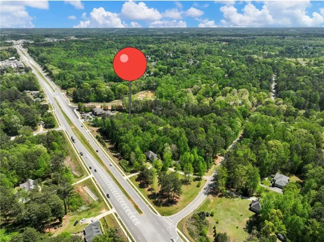 Expansive wooded acreage featuring significant road frontage and multiple potential access points