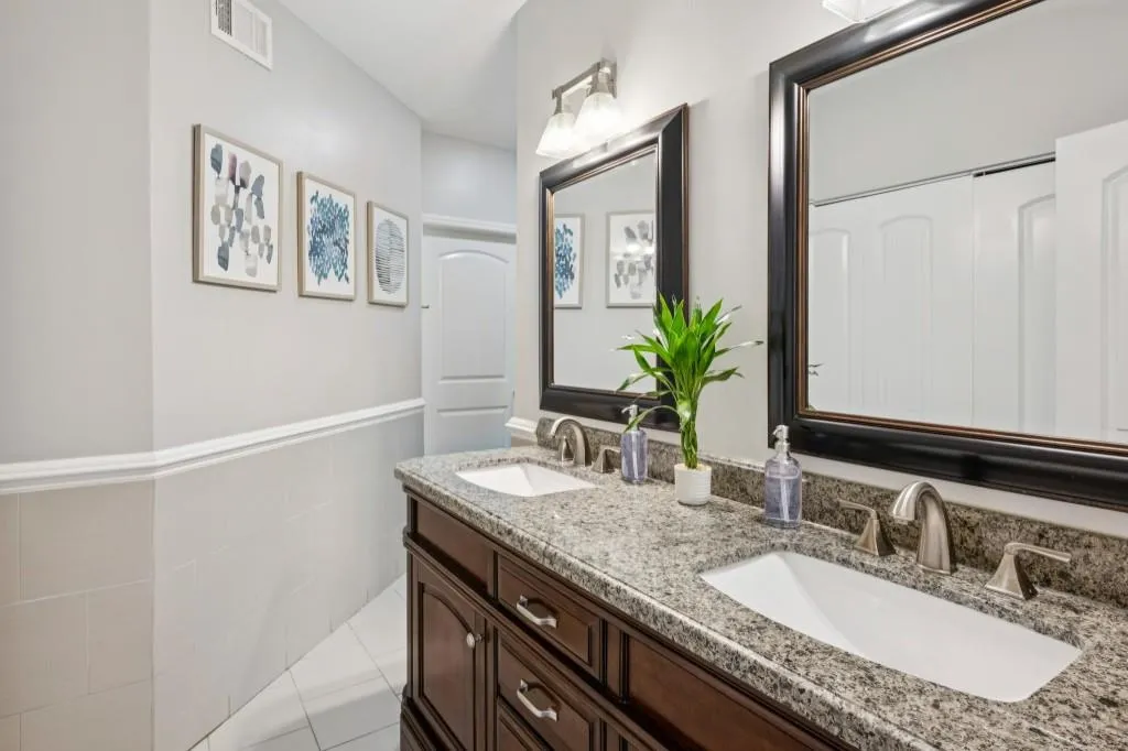 A Primary Ensuite offers a Double Stone Vanity, Glass Shower, and Walk-In Closet, while the Secondary Bedroom boasts direct terrace access, its own Walk-In Closet, and a nearby Full Bath. E