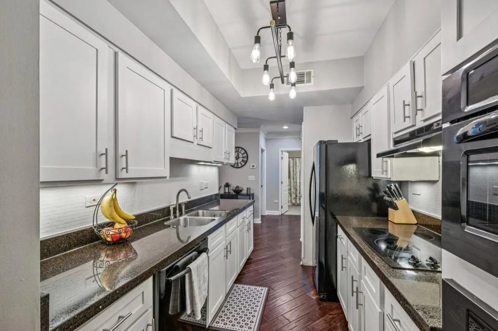 The Chef's Kitchen features Granite Countertops, White Shaker Cabinets, and a timeless Subway Tile Backsplash, flowing effortlessly into the Dining Area for easy open-concept living.