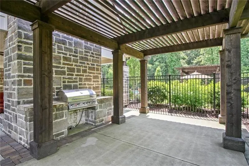 View of patio featuring a pergola and area for grilling