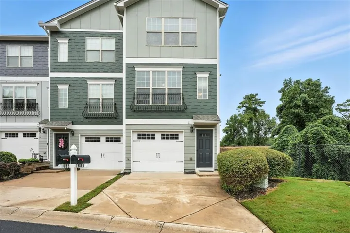 Traditional-style home featuring driveway, board and batten siding, and an attached garage