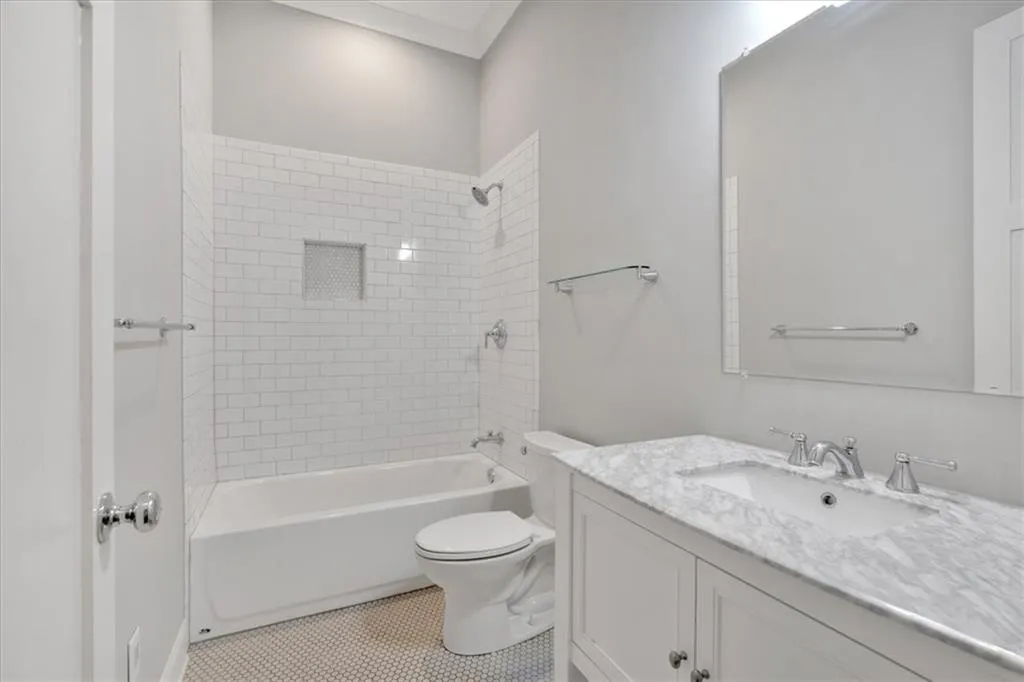 Bathroom featuring vanity and washtub / shower combination