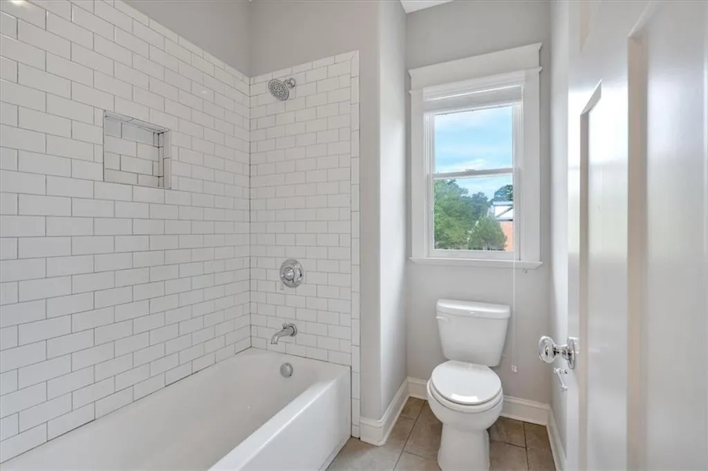 Full bath featuring tile patterned floors and bathing tub / shower combination