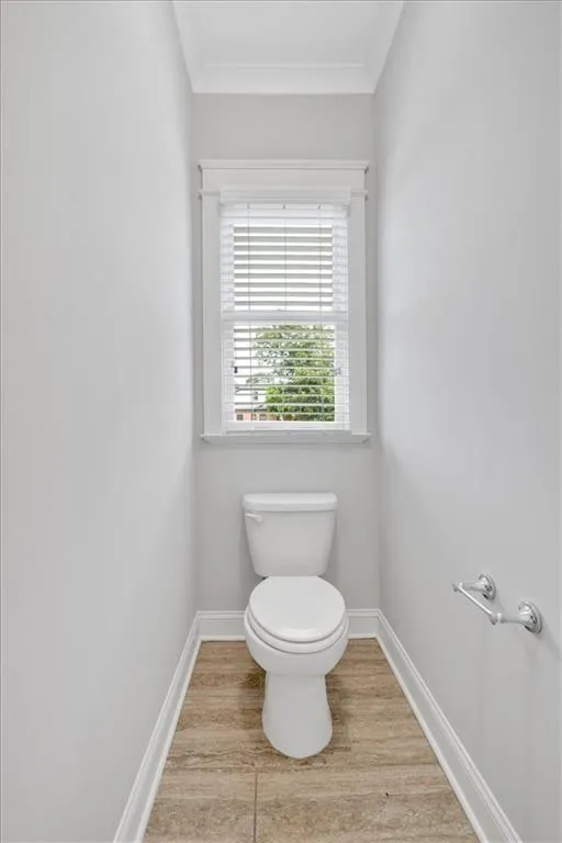 Master Bathroom with crown molding and wood finished floors