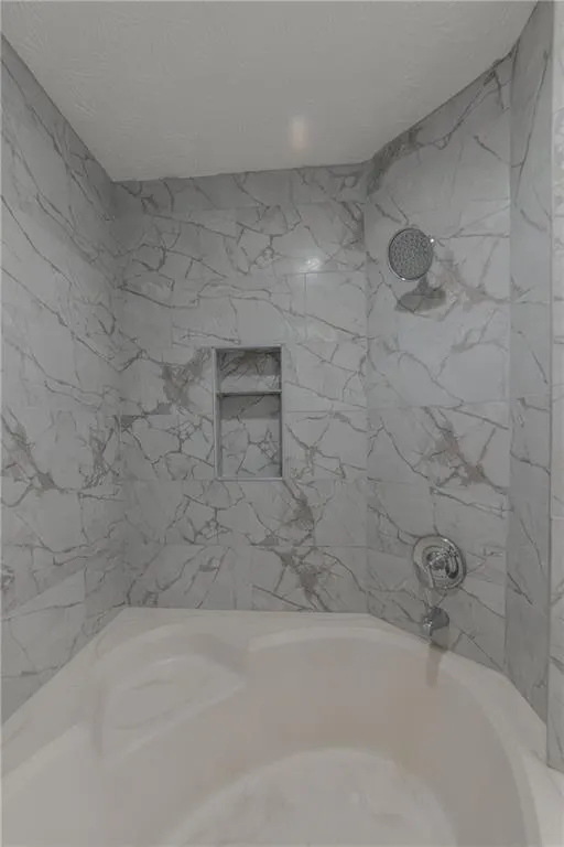 Bathroom with shower / washtub combination