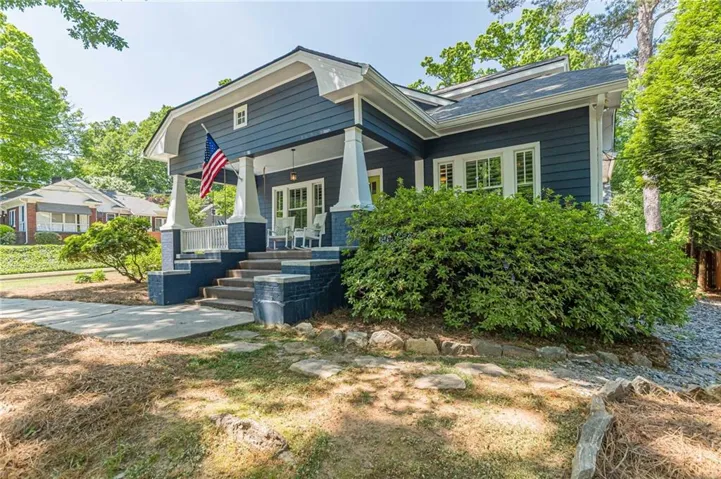 Craftsman-style exterior with a deep blue siding, white trim, and a covered front porch