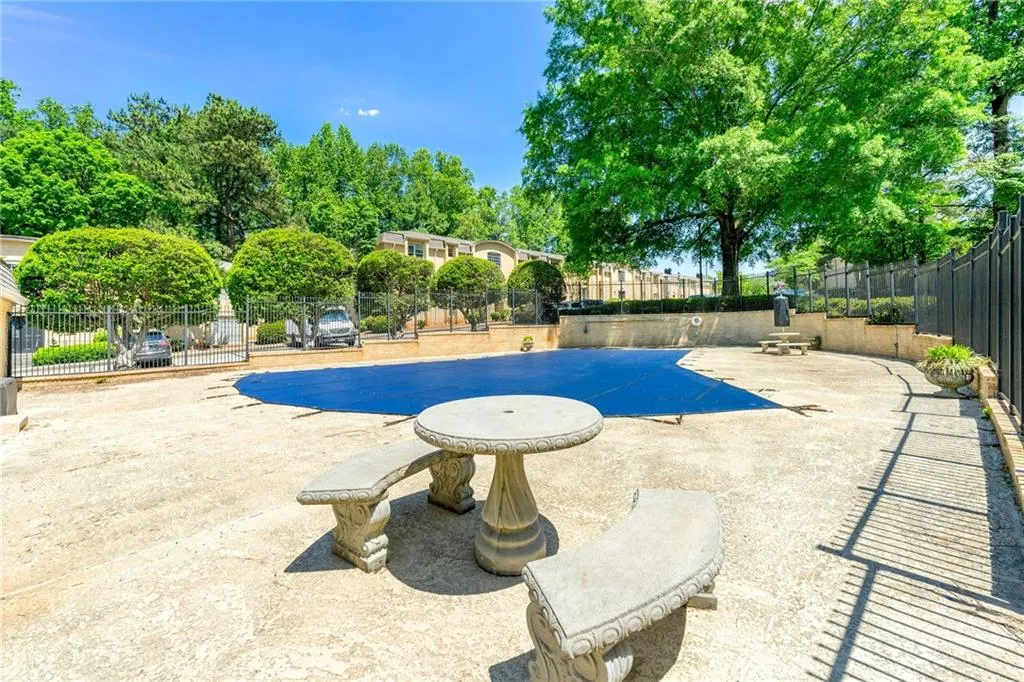 View of swimming pool featuring a patio area and fence
