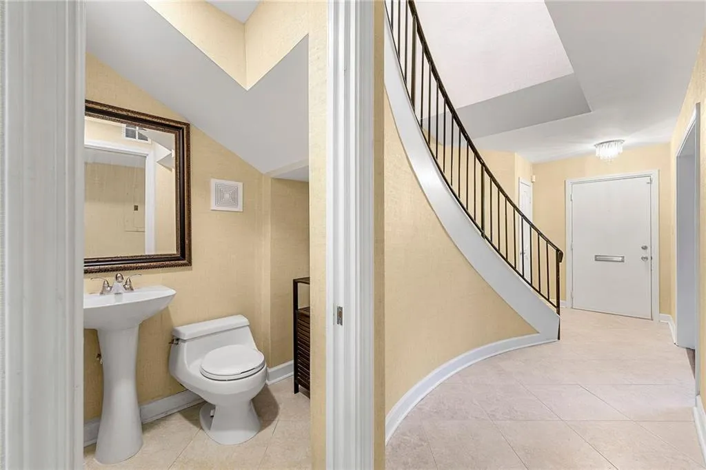 Bathroom with toilet, tile patterned flooring, and visible vents
