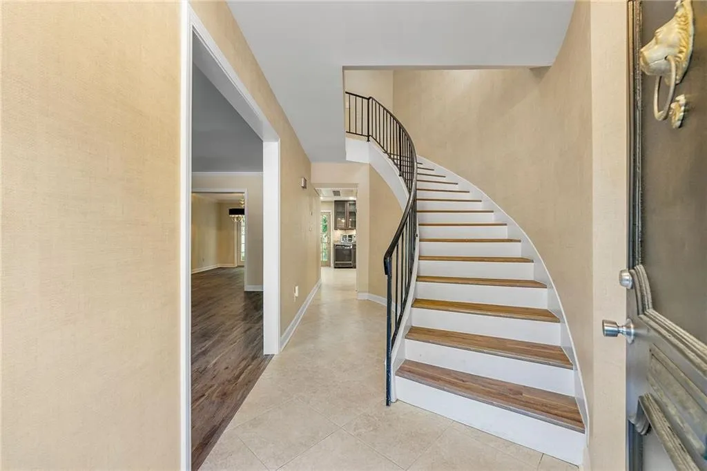 Stairs featuring tile patterned flooring and baseboards