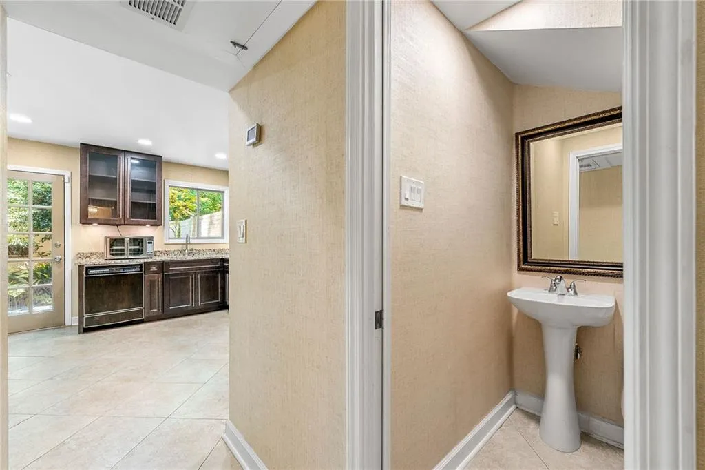 Bathroom featuring baseboards, a sink, tile patterned flooring, and visible vents