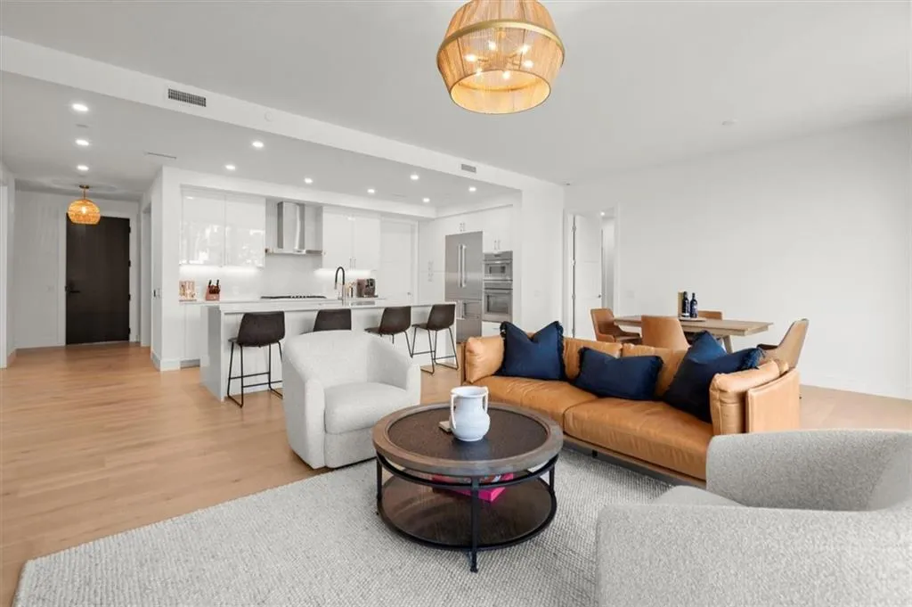 This open-concept great room is framed by warm wood tones, layered textures, and natural light that amplifies the volume of the space. This open-concept great room is framed by warm wood tones, layered textures, and natural light that amplifies the volume of the space.