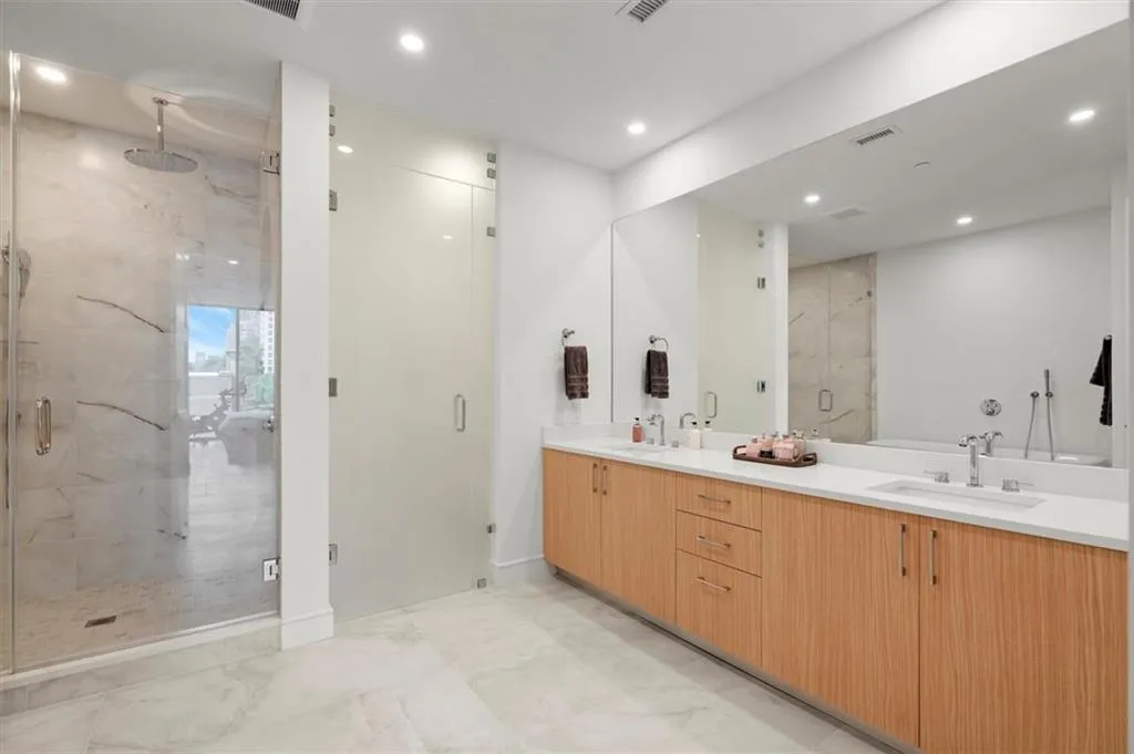 The bathrooms echo the residence's modern aesthetic of clean lines and rich textures. The bathrooms echo the residence's modern aesthetic of clean lines and rich textures.