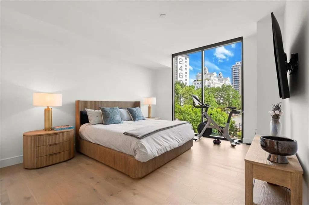 Primary suite captures skyline views and floor-to-ceiling windows. Primary suite captures skyline views and floor-to-ceiling windows.