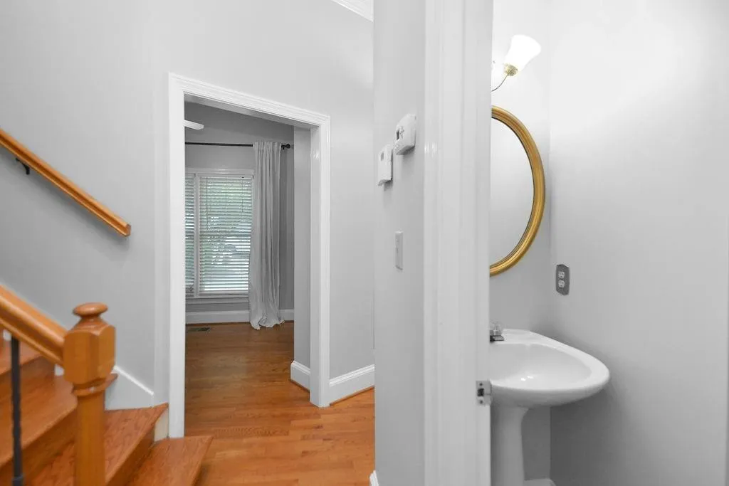 Half Bathroom featuring wood finished floors and baseboards