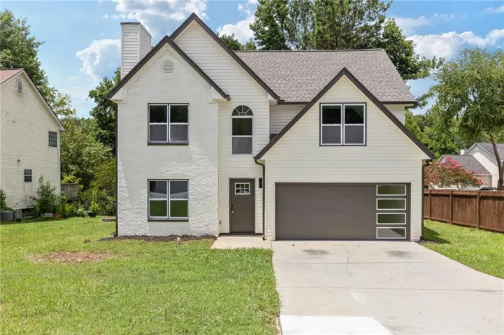 Contemporary two-story exterior featuring white siding and stucco finishes