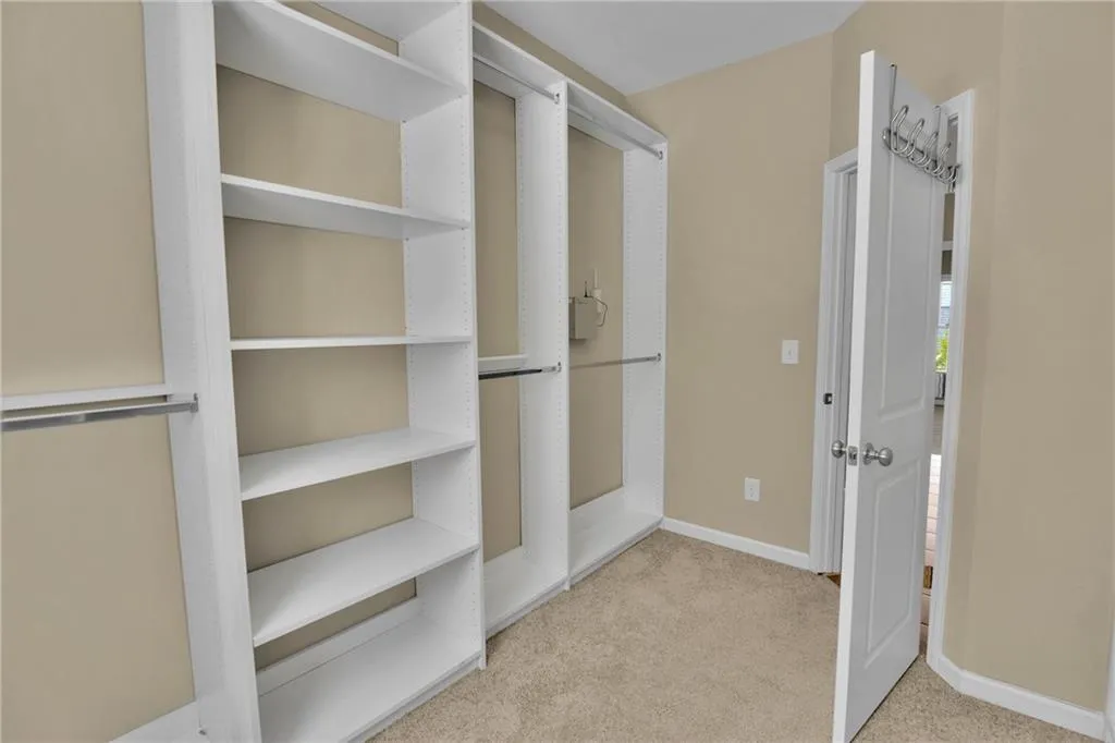 Primary Walk in closet with custom shelving