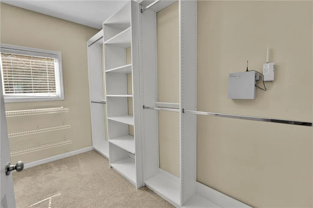 Primary Walk in closet with natural lighting