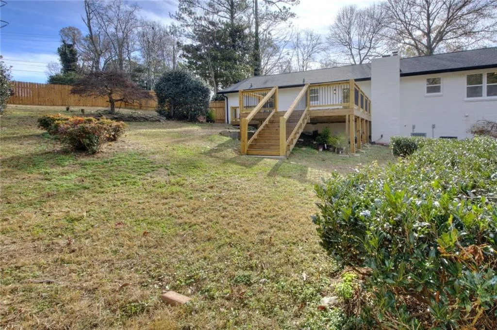 View of yard featuring stairway and a wooden deck