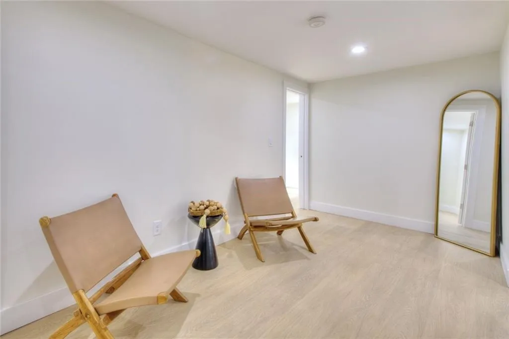 Sitting room featuring light wood-style flooring and recessed lighting