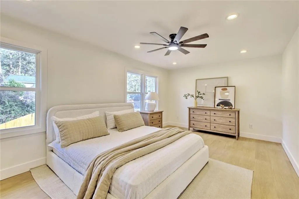 Bedroom featuring light wood finished floors, a ceiling fan, and recessed lighting