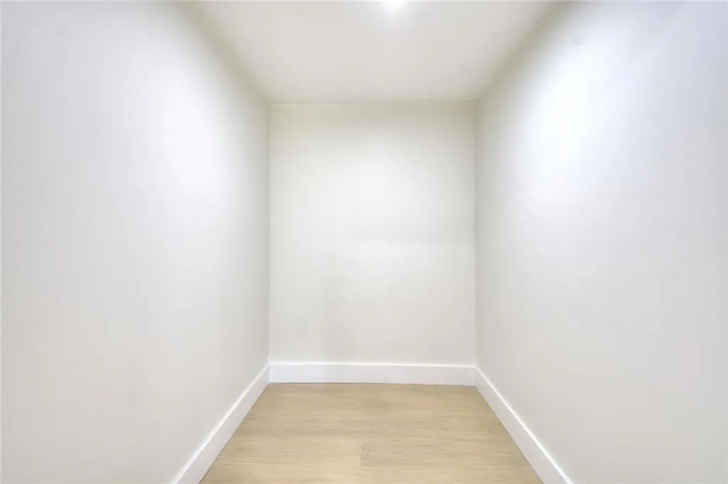 Unfurnished room featuring light wood-style floors and baseboards