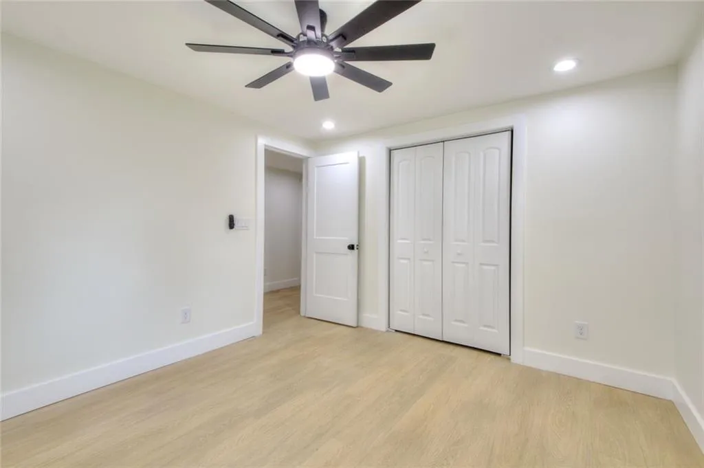 Unfurnished bedroom with light wood-style floors, ceiling fan, recessed lighting, and a closet