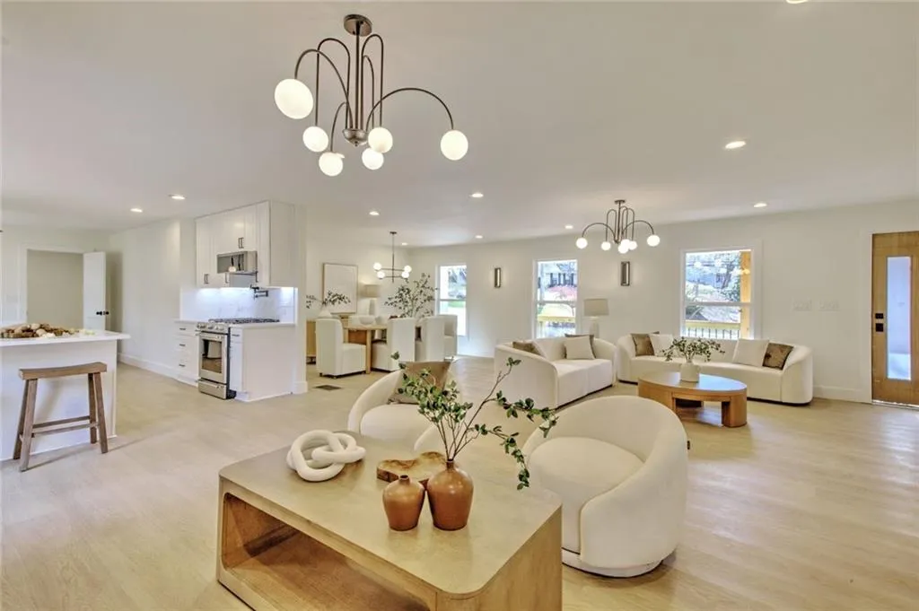 Living room featuring recessed lighting, light wood finished floors, and a chandelier