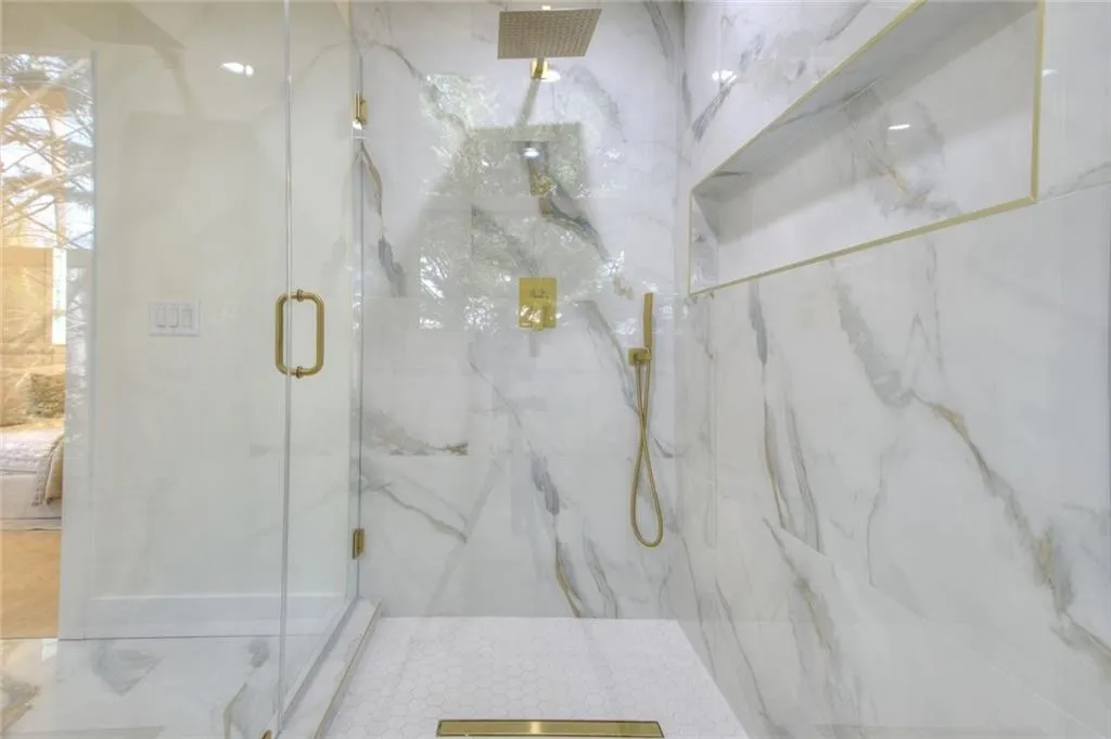 Ensuite bathroom with a marble finish shower