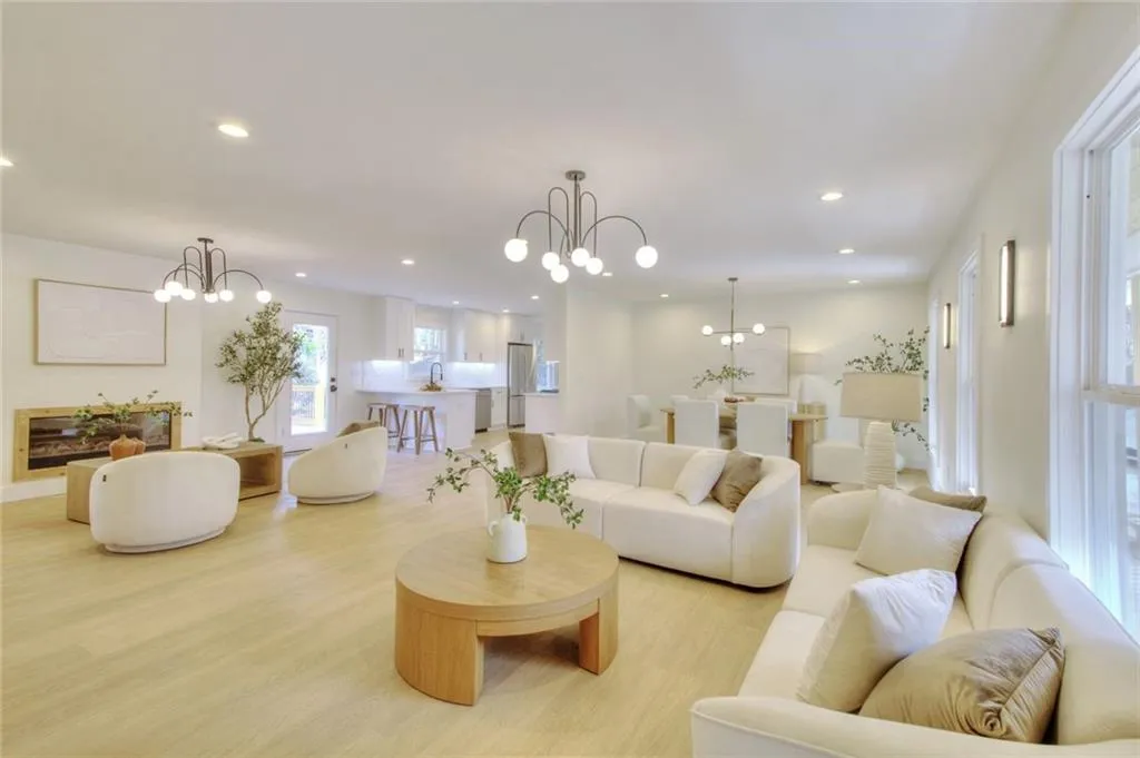 Living area with a chandelier, recessed lighting, and wood finished floors