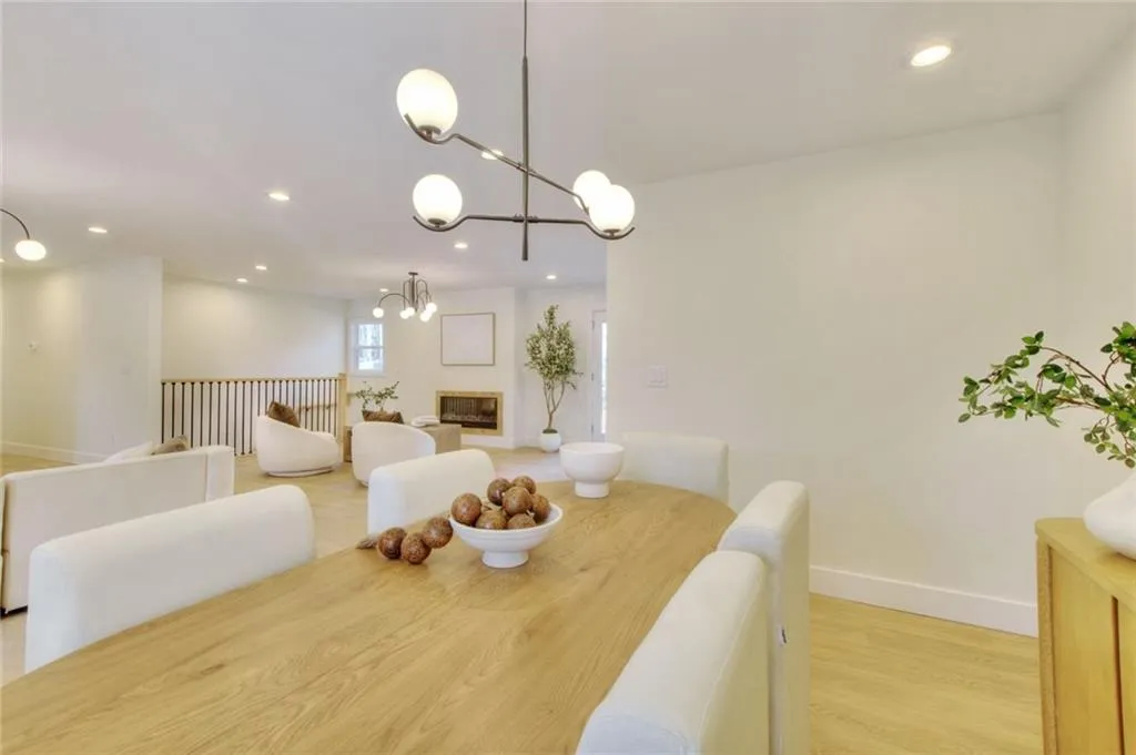 Dining area featuring recessed lighting, light wood-style floors, and a chandelier