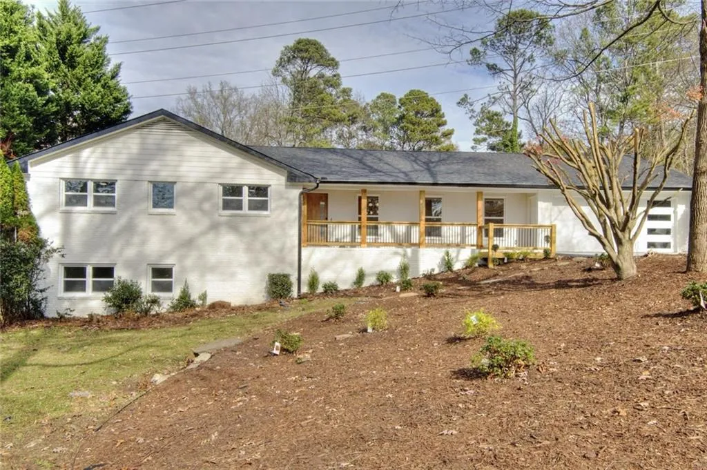 Back of property featuring a porch and brick siding