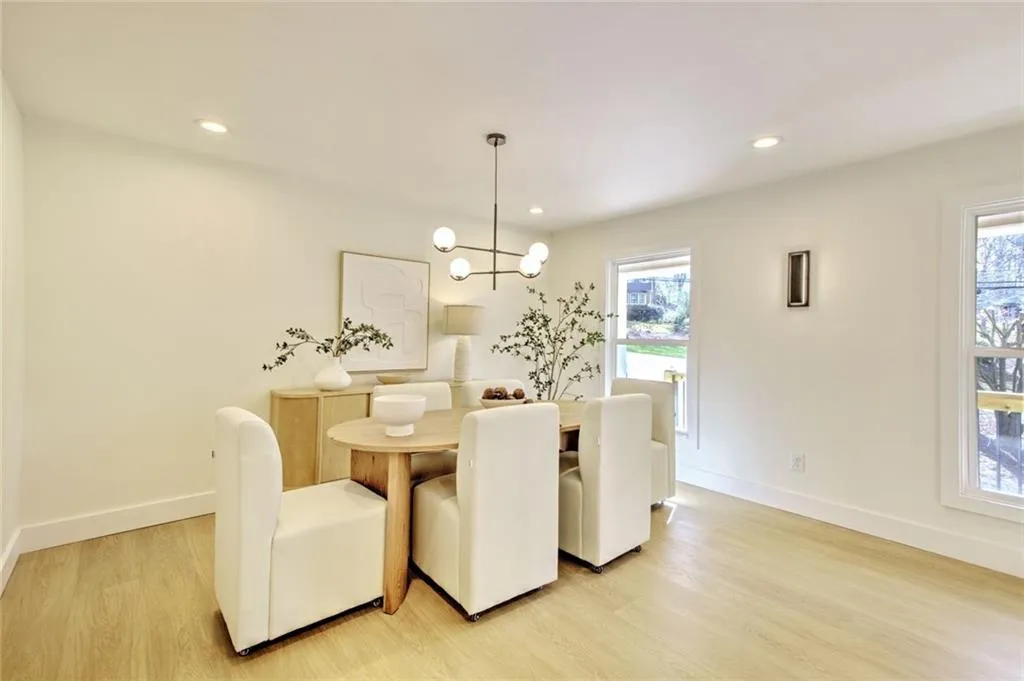Dining area featuring light wood-style flooring, a chandelier, and recessed lighting